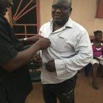 Chief Tony Amechi dressing up Roland Odalonunu